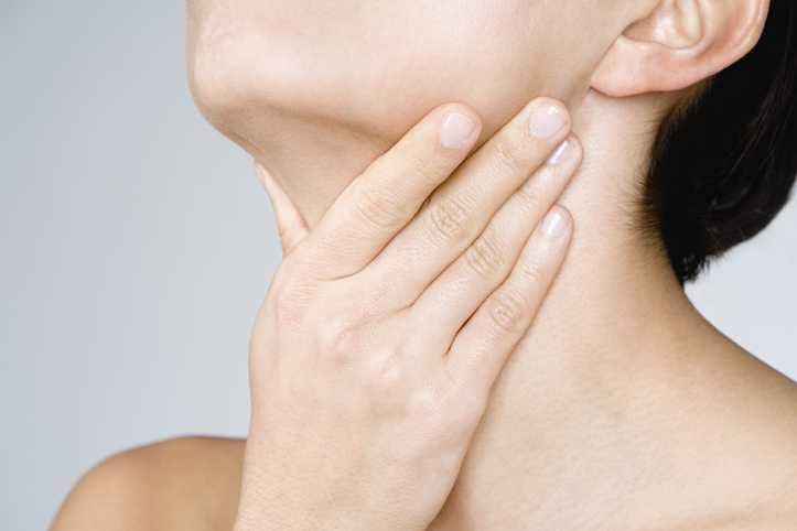 Woman touching her neck
