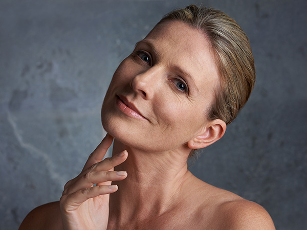 Beautiful mature woman touching her neck