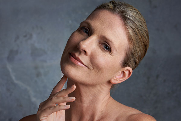 Ageless beauty older woman touching face