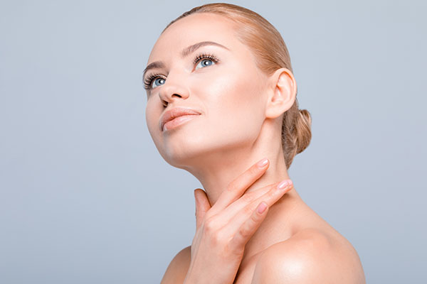 Gorgeous young woman happy woman touching her face